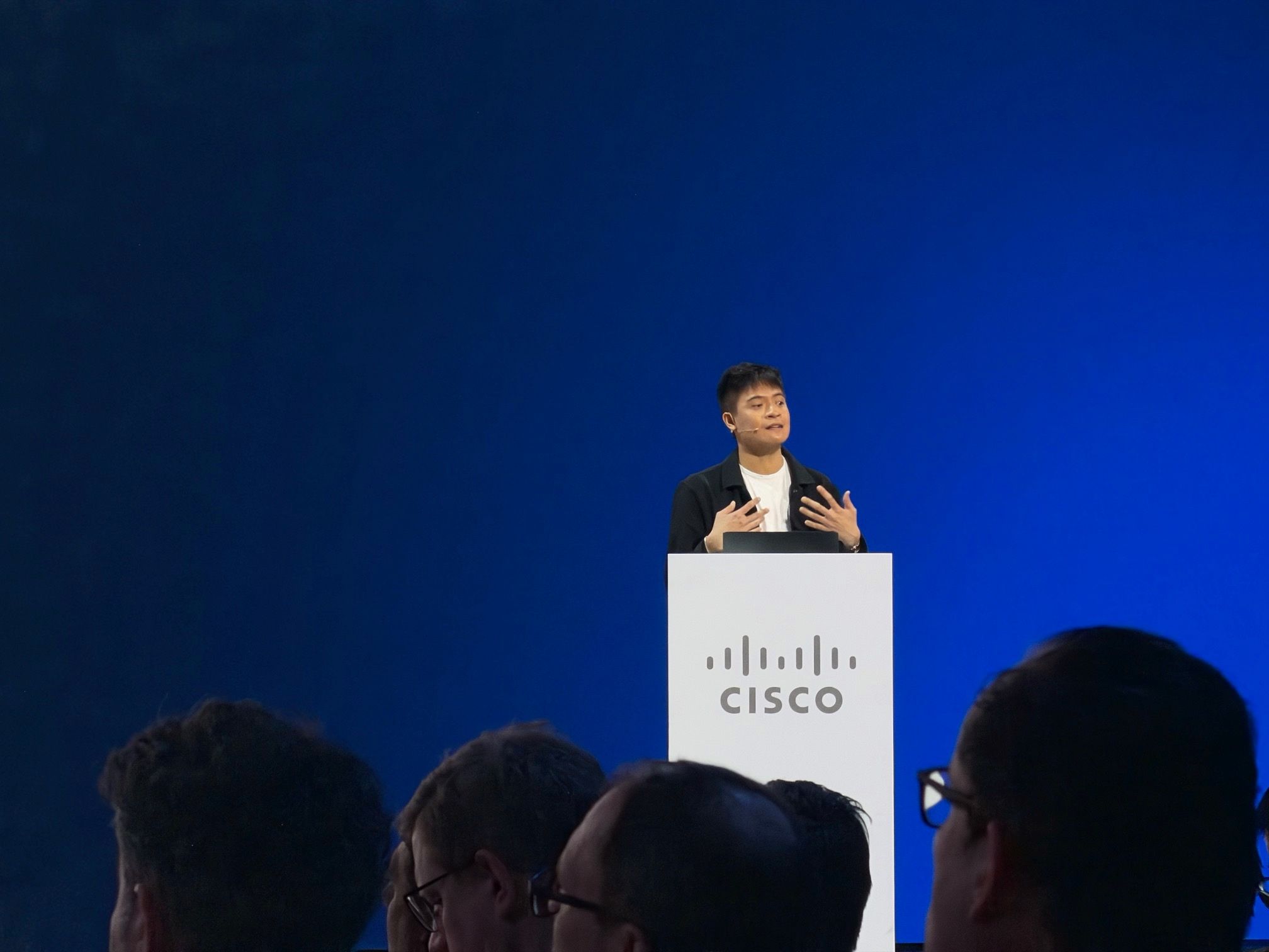 Benson Lao speaking at a Cisco podium